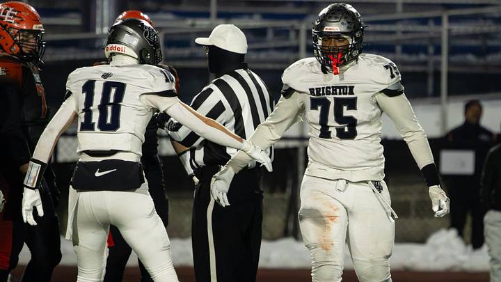 Brighton's Zahmar Tookes, right, gets a high-five from Alberto Atwell during the NYSPHSAA Class A semifinals Sunday, Nov. 30 at Cicero-North Syracuse High School.