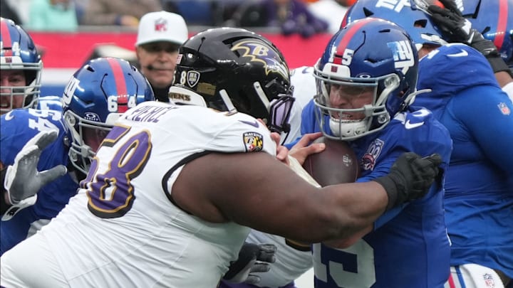 East Rutherford, NJ -- December 15, 2024 -- Michael Pierce of the Ravens hits Tommy DeVito of the Giants taking a late hit penalty in the first half. The Baltimore Ravens came to MetLife Stadium to play the New York Giants.