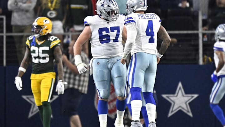 Dallas Cowboys quarterback Dak Prescott celebrates with center Brock Hoffman after a touchdown against the Green Bay Packers.