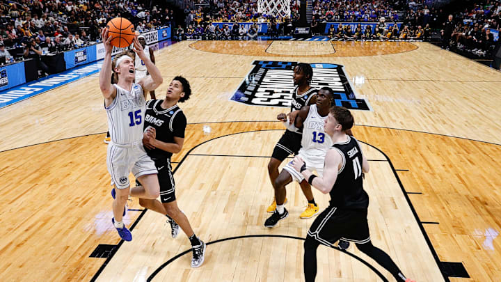 Mar 20, 2025; Denver, CO, USA; Brigham Young Cougars forward Richie Saunders (15) drives to the net against VCU Rams forward Luke Bamgboye (9) as guard Max Shulga (11) an dcenter Keba Keita (13) and forward Luke Bamgboye (9) defend in the second half at Ball Arena. Mandatory Credit: Isaiah J. Downing-Imagn Images