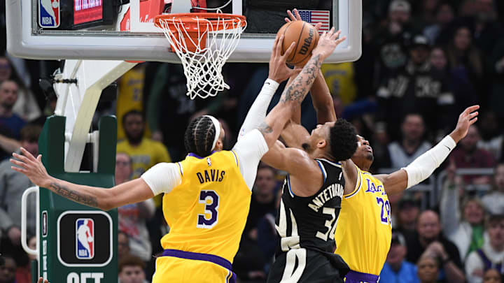 Mar 26, 2024; Milwaukee, Wisconsin, USA; Milwaukee Bucks forward Giannis Antetokounmpo (34) puts up a shot against Los Angeles Lakers forward Anthony Davis (3) and Los Angeles Lakers forward Rui Hachimura (28) in the second overtime at Fiserv Forum. Mandatory Credit: Michael McLoone-Imagn Images
