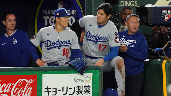 Mar 18, 2025; Bunkyo, Tokyo, JPN; Los Angeles Dodgers starting pitcher Yoshinobu Yamamoto (18) and designated hitter Shohei Ohtani (17) stand in the dugout during the fifth inning against the Chicago Cubs during the Tokyo Series at Tokyo Dome. Mandatory Credit: Darren Yamashita-Imagn Images