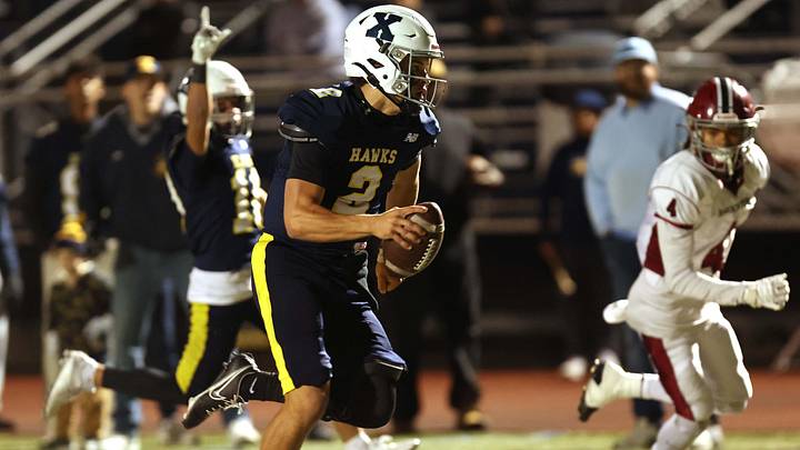 Xaverian Brothers quarterback Will Wood scores a touchdown during a Division I football game against Brockton. 