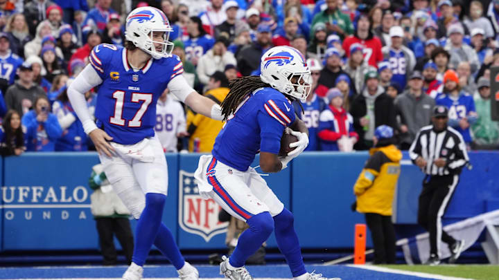 Buffalo Bills quarterback Josh Allen hands off the ball to Buffalo Bills running back James Cook during the second half at Highmark Stadium.