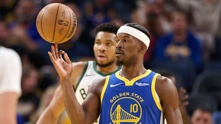 Jan 7, 2026; San Francisco, California, USA; Golden State Warriors forward Jimmy Butler III (10) spins the ball on his finger and Milwaukee Bucks forward Giannis Antetokounmpo (34) looks on during a stoppage of play in the third quarter at Chase Center. 