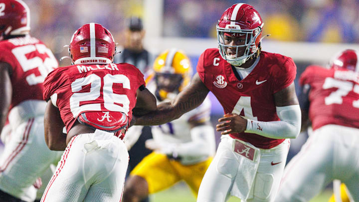 Alabama Crimson Tide quarterback Jalen Milroe (4) hands the ball off to Alabama Crimson Tide running back Jam Miller (26)