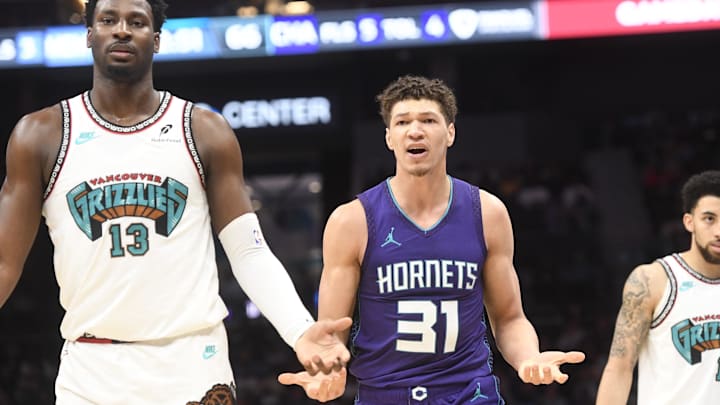 Apr 8, 2025; Charlotte, North Carolina, USA;  Charlotte Hornets forward Tidjane Salaun (31) complains after he is called on a foul against Memphis Grizzlies forward center Jaren Jackson Jr. (13) during the second half at the Spectrum Center. Mandatory Credit: Sam Sharpe-Imagn Images