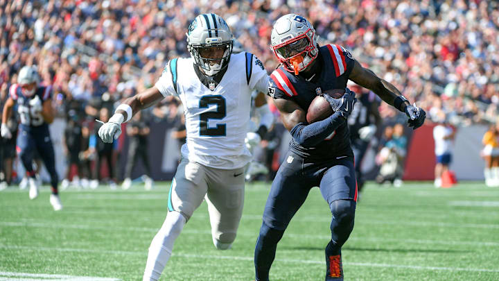 Sep 28, 2025; Foxborough, Massachusetts, USA; New England Patriots wide receiver Stefon Diggs (8) runs the ball while Carolina Panthers cornerback Mike Jackson (2) defends during the first half at Gillette Stadium. Mandatory Credit: Bob DeChiara-Imagn Images