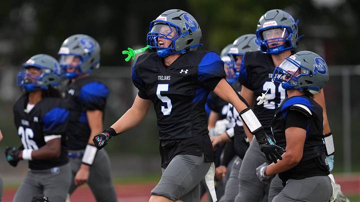 Green Bay Southwest High School's Carsen Zeuske (5) runs onto the field at the start of the team's football game against Sheboygan South High School on Aug. 21, 2026 in Green Bay, Wis. Green Bay Southwest defeated Sheboygan South 33-13 in the team's first win since September 2022.