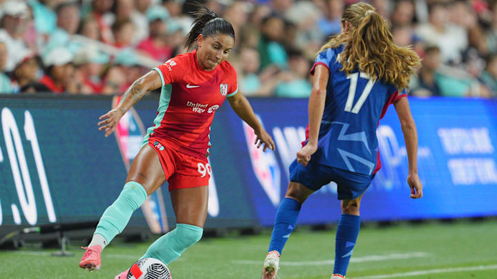 Aug 6, 2024; Kansas City, MO, USA;  Kansas City Current midfielder Debinha (99) plays the ball defended by North Carolina Courage midfielder Dani Weatherholt (17) in the second half at CPKC Stadium. Mandatory Credit: Jay Biggerstaff-USA TODAY Sports