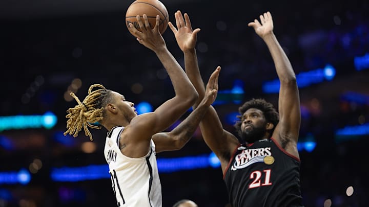 Dec 23, 2025; Philadelphia, Pennsylvania, USA; Brooklyn Nets forward Noah Clowney (21) drives for a shot against Philadelphia 76ers center Joel Embiid (21) during the second quarter at Xfinity Mobile Arena. Mandatory Credit: Bill Streicher-Imagn Images