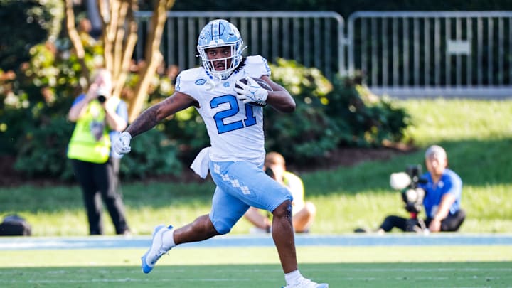 Sep 28, 2024; Durham, North Carolina, USA;  North Carolina Tar Heels running back Davion Gause (21) runs with the ball during the first half of the game against Duke Blue Devils at Wallace Wade Stadium. Mandatory Credit: Jaylynn Nash-Imagn Images