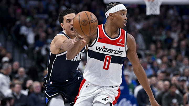 Feb 12, 2024; Dallas, Texas, USA; Dallas Mavericks guard Josh Green (8) knocks the ball away from Washington Wizards guard Bilal Coulibaly (0) during the second quarter at the American Airlines Center. Mandatory Credit: Jerome Miron-Imagn Images