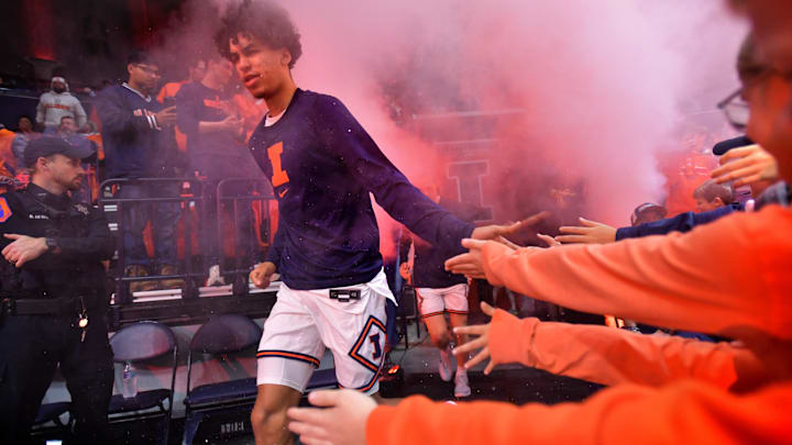Nov 25, 2024; Champaign, Illinois, USA;  Illinois Fighting Illini forward Will Riley (7) gets a hand from fans as he takes the court before a game against the Little Rock Trojans during the first half at State Farm Center. Mandatory Credit: Ron Johnson-Imagn Images