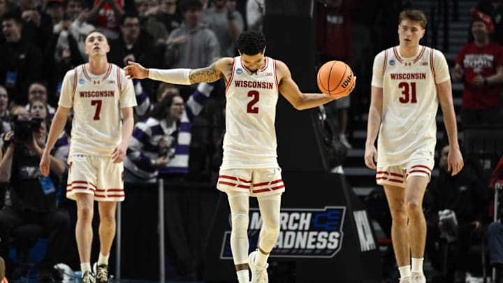Mar 19, 2026; Portland, OR, USA; Wisconsin Badgers guard Andrew Rohde (7), guard Nick Boyd (2), and forward Nolan Winter (31) react during the second half of a first round game of the men's 2026 NCAA Tournament against the High Point Panthers at Moda Center. 