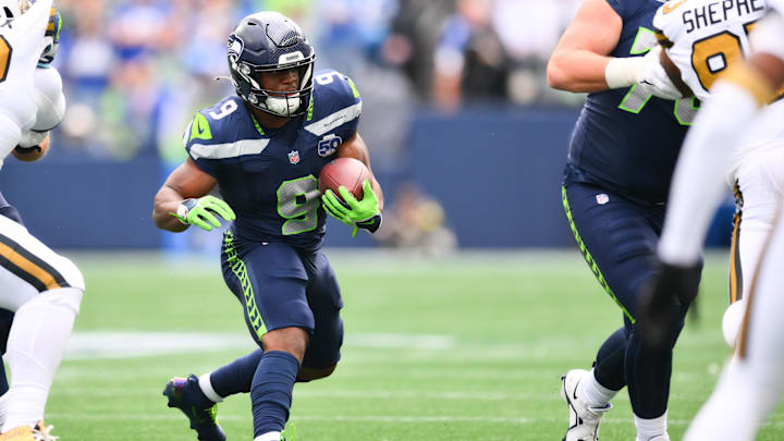 Sep 21, 2025; Seattle, Washington, USA; Seattle Seahawks running back Kenneth Walker III (9) runs with the ball during the first half at Lumen Field. Mandatory Credit: Steven Bisig-Imagn Images