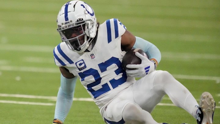 Dec 22, 2024; Indianapolis, Indiana, USA; Indianapolis Colts cornerback Kenny Moore II (23) slides to the turf after intercepting a pass at the end of the game during a game against the Tennessee Titans at Lucas Oil Stadium.