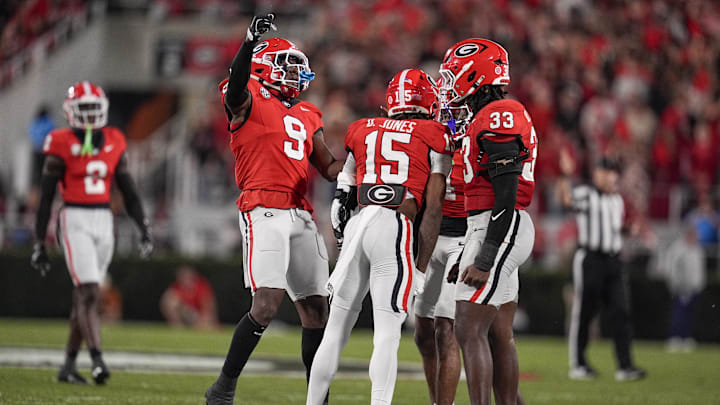 Nov 15, 2025; Athens, Georgia, USA; Georgia Bulldogs defensive back Demello Jones (15) celebrates a tackle with linebacker Chris Cole (9) and linebacker Quintavius Johnson (33) in the first half against the Texas Longhorns at Sanford Stadium. Mandatory Credit: Dale Zanine-Imagn Images