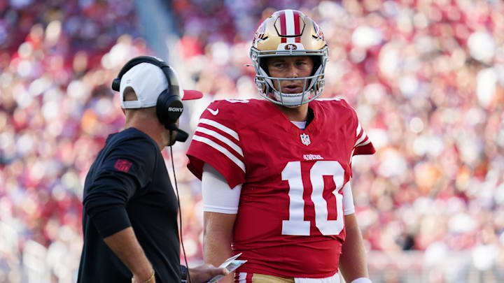 Aug 9, 2025; Santa Clara, California, USA;  San Francisco 49ers quarterback Mac Jones (10) talks with quarterbacks coach Mick Lombardi in the first quarter against the Denver Broncos at Levi's Stadium. Mandatory Credit: David Gonzales-Imagn Images