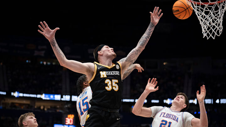 Missouri Tigers guard Jacob Crews (35) and Florida Gators forward Alex Condon (21) look for a rebound during the second half of their quarterfinal game of the SEC Men's Basketball Tournament at Bridgestone Arena in Nashville, Tenn., Friday, March 14, 2025.