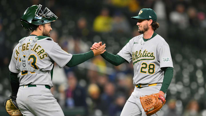 Mar 28, 2025; Seattle, Washington, USA; Athletics first base Tyler Soderstrom (21) and relief pitcher Mitch Spence (28) celebrate defeating the Seattle Mariners at T-Mobile Park. Mandatory Credit: Steven Bisig-Imagn Images Mar 28, 2025; Seattle, Washington, USA; Athletics first base Tyler Soderstrom (21) and relief pitcher Mitch Spence (28) celebrate defeating the Seattle Mariners at T-Mobile Park. Mandatory Credit: Steven Bisig-Imagn Images