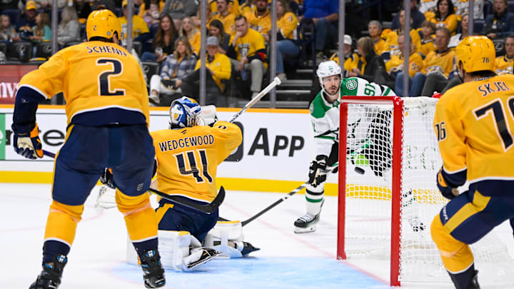 Oct 10, 2024; Nashville, Tennessee, USA;  Nashville Predators goaltender Scott Wedgewood (41) deflects the puck against the Dallas Stars during the second period at Bridgestone Arena. Mandatory Credit: Steve Roberts-Imagn Images