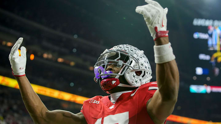 Ohio State Buckeyes wide receiver Carnell Tate (17) celebrates a touchdown Saturday, Dec. 6, 2025, during the Big Ten football championship against the Indiana Hoosiers at Lucas Oil Stadium in Indianapolis.