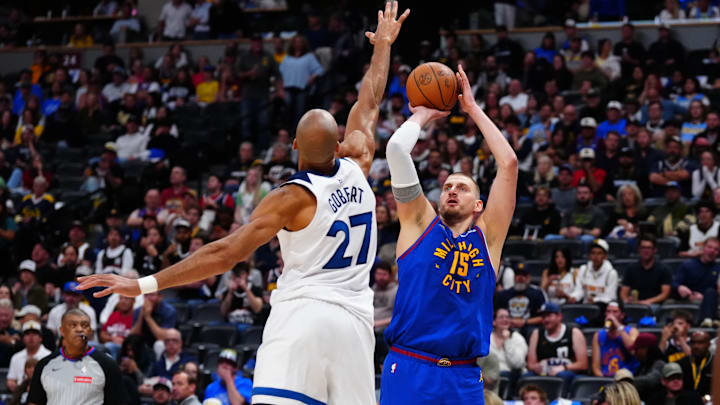 Apr 20, 2026; Denver, Colorado, USA; Minnesota Timberwolves center Rudy Gobert (27) defends on Denver Nuggets center Nikola Jokic (15) in the second half during game two of the first round of the 2026 NBA Playoffs at Ball Arena.