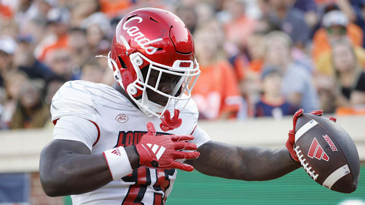 Oct 12, 2024; Charlottesville, Virginia, USA; Louisville Cardinals running back Isaac Brown (25) celebrates after scoring a touchdown against the Virginia Cavaliers during the second half at Scott Stadium. Mandatory Credit: Amber Searls-Imagn Images
