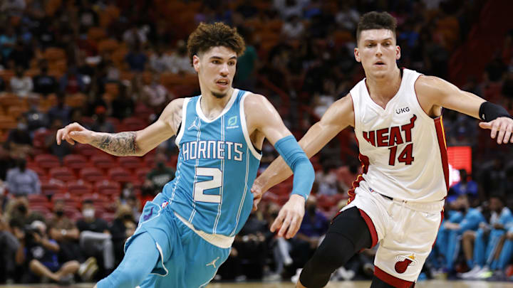 Oct 11, 2021; Miami, Florida, USA;  Charlotte Hornets guard LaMelo Ball drives the ball past Miami Heat guard Tyler Herro (14) during the first half at FTX Arena. Mandatory Credit: Rhona Wise-Imagn Images
