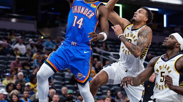 Oct 11, 2025; Indianapolis, Indiana, USA; Oklahoma City Thunder guard Jazian Gortman (14) shoots the ball while Indiana Pacers forward Jalen Slawson (18) defends in the second half at Gainbridge Fieldhouse. Mandatory Credit: Trevor Ruszkowski-Imagn Images