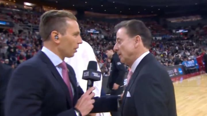 Evan Washburn interviews St. John’s head coach Rick Pitino during second-round game against Arkansas.