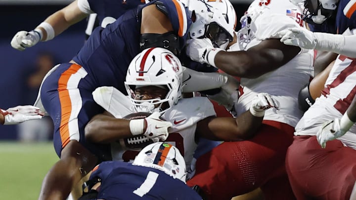 Sep 20, 2025; Charlottesville, Virginia, USA; Stanford Cardinal running back Micah Ford (20) is tackled by Virginia Cavaliers linebacker James Jackson (1) while carrying the ball on a fourth down conversion during the fourth quarter at Scott Stadium. Mandatory Credit: Geoff Burke-Imagn Images