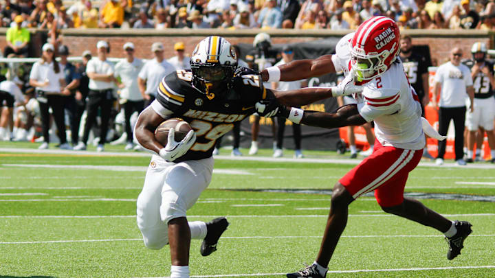 Sept. 13, 2025; Columbia, Missouri, USA; Missouri Tigers running back Ahmad Hardy pushes away from Louisiana Ragin' Cajuns' safety Jalen Clark on his way to the end zone. Sept. 13, 2025; Columbia, Missouri, USA; Missouri Tigers running back Ahmad Hardy pushes away from Louisiana Ragin' Cajuns' safety Jalen Clark on his way to the end zone.
