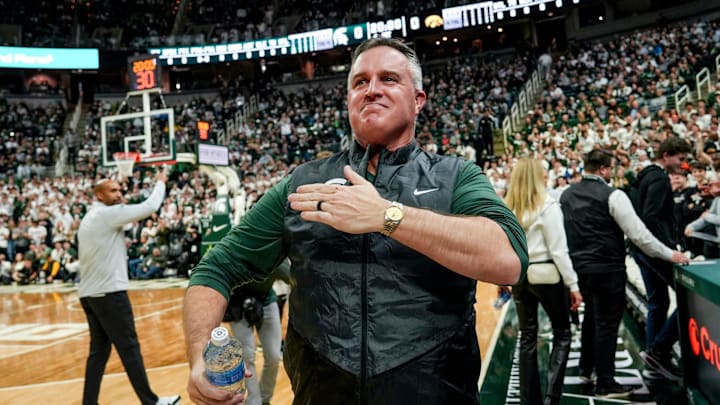 Michigan State's new football coach Pat Fitzgerald pats his heart at the crowd in attendance for the Spartans basketball game against Iowa on Tuesday, Dec. 2, 2025, at the Breslin Center in East Lansing.