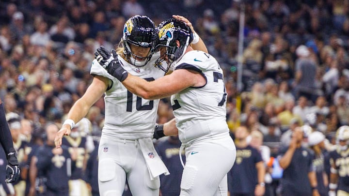 Aug 17, 2025; New Orleans, Louisiana, USA;  Jacksonville Jaguars quarterback Trevor Lawrence (16) and offensive tackle Walker Little (72) celebrate a touchdown against the New Orleans Saints during the first half at Caesars Superdome. Mandatory Credit: Stephen Lew-Imagn Images