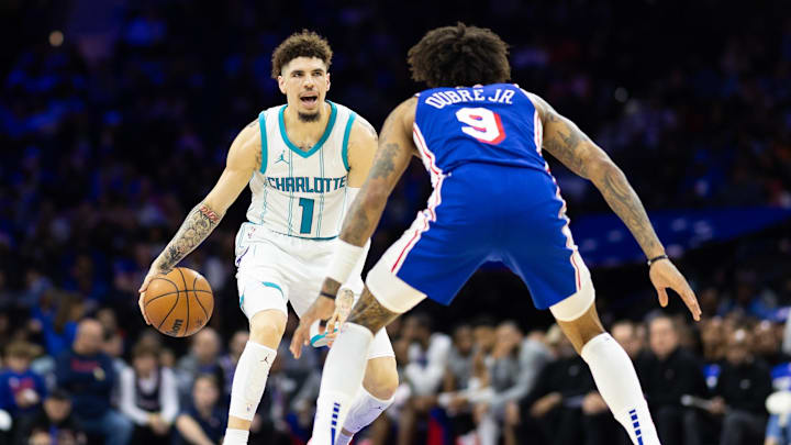 Nov 10, 2024; Philadelphia, Pennsylvania, USA; Charlotte Hornets guard LaMelo Ball (1) dribbles the ball against Philadelphia 76ers guard Kelly Oubre Jr. (9) during the second quarter at Wells Fargo Center. Mandatory Credit: Bill Streicher-Imagn Images