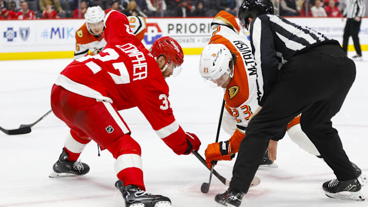 Feb 23, 2025; Detroit, Michigan, USA; Anaheim Ducks center Mason McTavish (23) faces off against Detroit Red Wings left wing J.T. Compher (37) during the third period of the game between the Detroit Red Wings and the Anaheim Ducks at Little Caesars Arena. Mandatory Credit: Brian Bradshaw Sevald-Imagn Images