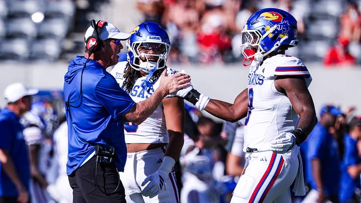 Nov 8, 2025; Tucson, Arizona, USA; Kansas Jayhawks defensive end Dakyus Brinkley (9) high fives head coach Lance Leipold during the second quarter of the game against the Arizona Wildcats at Arizona Stadium. Mandatory Credit: Aryanna Frank-Imagn Images Nov 8, 2025; Tucson, Arizona, USA; Kansas Jayhawks defensive end Dakyus Brinkley (9) high fives head coach Lance Leipold during the second quarter of the game against the Arizona Wildcats at Arizona Stadium. Mandatory Credit: Aryanna Frank-Imagn Images
