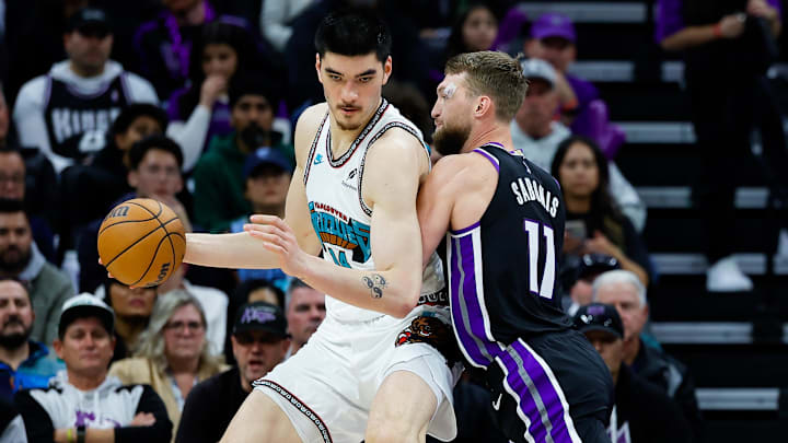 Mar 17, 2025; Sacramento, California, USA; Memphis Grizzlies center Zach Edey (14) controls the ball against Sacramento Kings forward Domantas Sabonis (11) during the second quarter at Golden 1 Center. Mandatory Credit: Sergio Estrada-Imagn Images