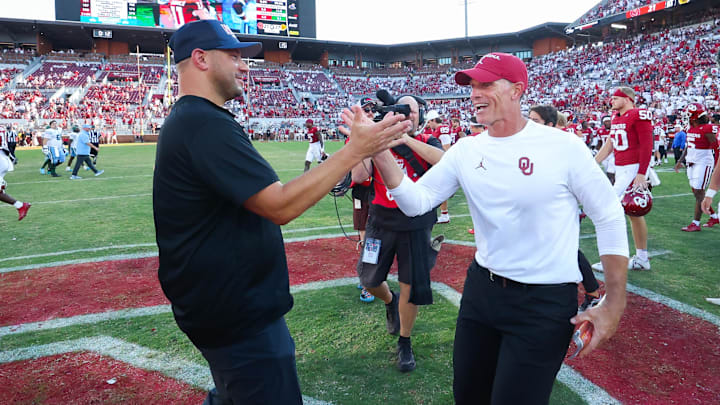 Tulane Green Wave head coach Jon Sumrall shakes hands with Oklahoma Sooners head coach Brent Venables