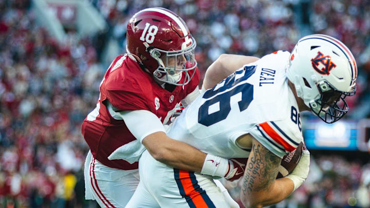 Nov 30, 2024; Tuscaloosa, Alabama, USA; Alabama Crimson Tide defensive back Bray Hubbard (18) grabs onto Auburn Tigers tight end Luke Deal (86) during the second quarter at Bryant-Denny Stadium. Mandatory Credit: Will McLelland-Imagn Images