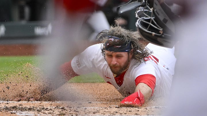May 25, 2025; St. Louis, Missouri, USA;  St. Louis Cardinals second baseman Brendan Donovan (33) slides in safe at home against the Arizona Diamondbacks during the first inning at Busch Stadium. Mandatory Credit: Jeff Curry-Imagn Images