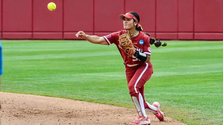 Oklahoma second baseman Ailana Agbayani throws to first base in an NCAA Tournament contest against Michigan. Oklahoma second baseman Ailana Agbayani throws to first base in an NCAA Tournament contest against Michigan.