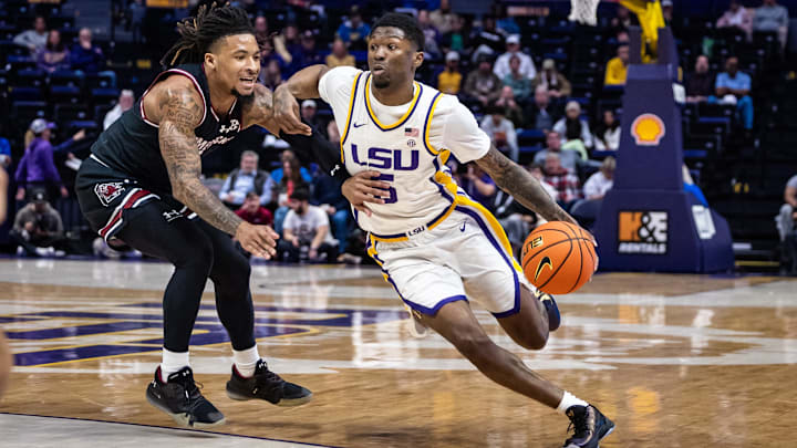 Feb 18, 2025; Baton Rouge, Louisiana, USA; LSU Tigers guard Cam Carter (5) dribbles against South Carolina Gamecocks guard Jamarii Thomas (6) during the first half at Pete Maravich Assembly Center. Mandatory Credit: Stephen Lew-Imagn Images Feb 18, 2025; Baton Rouge, Louisiana, USA; LSU Tigers guard Cam Carter (5) dribbles against South Carolina Gamecocks guard Jamarii Thomas (6) during the first half at Pete Maravich Assembly Center. Mandatory Credit: Stephen Lew-Imagn Images