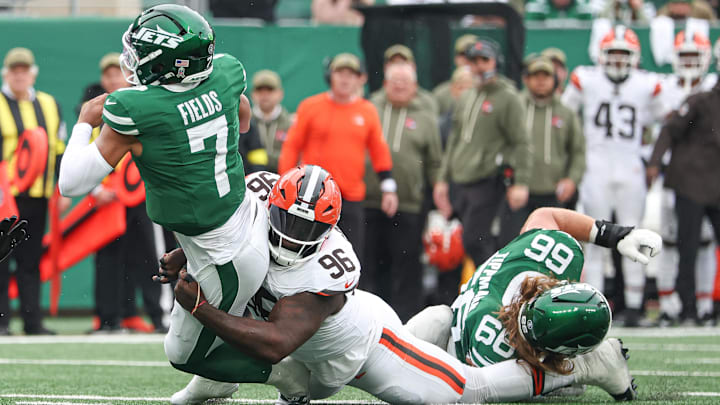 Nov 9, 2025; East Rutherford, New Jersey, USA;  New York Jets quarterback Justin Fields (7) is tackled by Cleveland Browns defensive tackle Maliek Collins (96) at MetLife Stadium. Mandatory Credit: Vincent Carchietta-Imagn Images