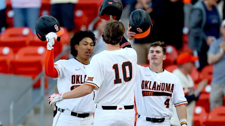 Oklahoma State's Nolan Schubart (10) celebrates a home run with Donovan LaSalle (19) and Zach Oklahoma State's Nolan Schubart (10) celebrates a home run with Donovan LaSalle (19) and Zach