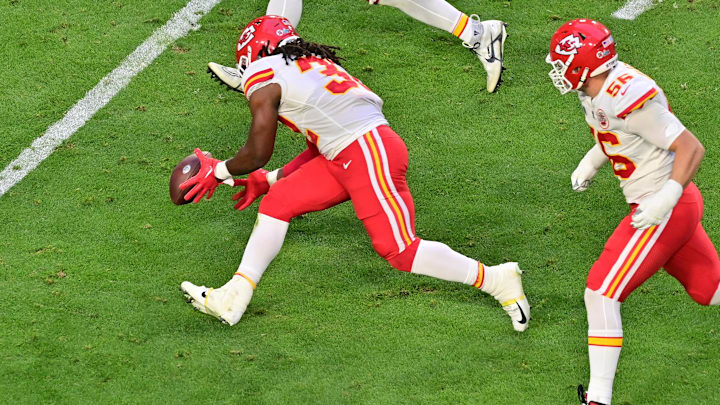 Feb 12, 2023; Glendale, Arizona, US; Kansas City Chiefs linebacker Nick Bolton (32) scoops up a fumble before returning it for a touchdown against the Philadelphia Eagles during the second quarter of Super Bowl LVII at State Farm Stadium. Mandatory Credit: Matt Kartozian-Imagn Images