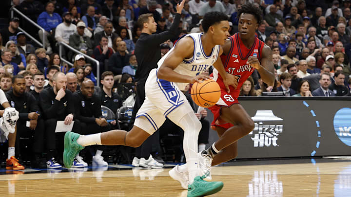 Mar 27, 2026; Washington, DC, USA; Duke Blue Devils guard Caleb Foster (1) dribbles the ball past St. John's Red Storm guard Joson Sanon (3) in the first half during a Sweet Sixteen game of the East Regional of the men's 2026 NCAA Tournament at Capital One Arena. Mandatory Credit: Geoff Burke-Imagn Images Mar 27, 2026; Washington, DC, USA; Duke Blue Devils guard Caleb Foster (1) dribbles the ball past St. John's Red Storm guard Joson Sanon (3) in the first half during a Sweet Sixteen game of the East Regional of the men's 2026 NCAA Tournament at Capital One Arena. Mandatory Credit: Geoff Burke-Imagn Images