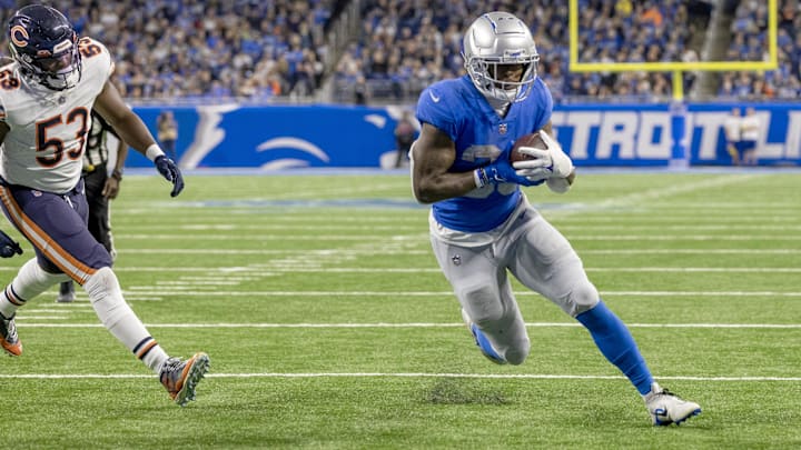 Jan 1, 2023; Detroit, Michigan, USA; Detroit Lions running back Jamaal Williams (30) runs with the ball for a touchdown against the Chicago Bears during the third quarter at Ford Field.